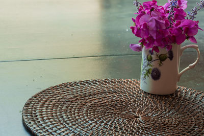 Close-up of pink flower vase on table