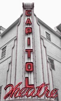 Low angle view of text on building against sky