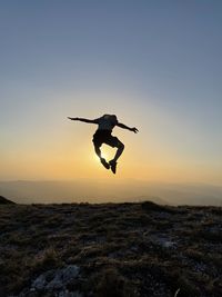 Low angle view of man jumping over land