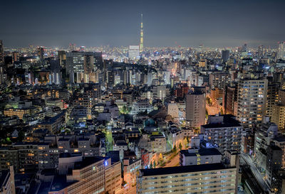 High angle view of city lit up at night