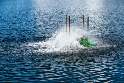 Paddle wheels aerators in lake, waste water treatment by fill oxygen into water.