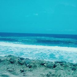 Scenic view of sea against clear blue sky