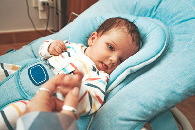 Cute baby girl on bed at home