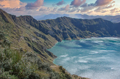 High angle view of sea and mountains against sky