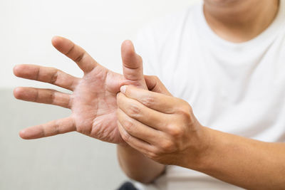 Close-up of woman hand over white background