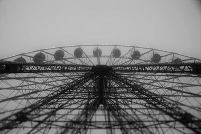 Low angle view of ferris wheel against sky