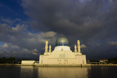 View of temple building against cloudy sky