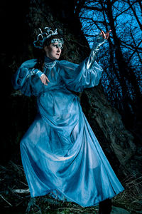 Portrait of woman standing in forest