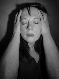 Close-up portrait of young woman with eyes closed