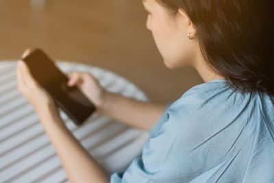 Midsection of woman using mobile phone