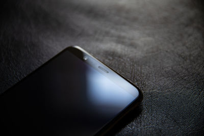 High angle view of mobile phone on table