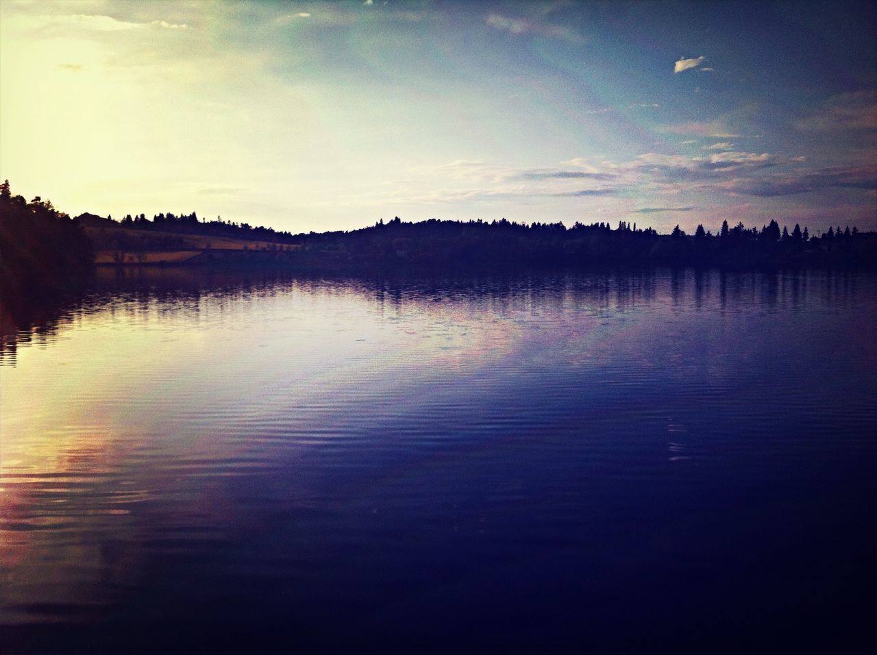 water, reflection, sunset, tranquil scene, tranquility, silhouette, scenics, sky, waterfront, lake, beauty in nature, nature, idyllic, dusk, calm, rippled, cloud - sky, outdoors, cloud, river