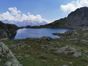 Scenic view of sea and mountains against sky