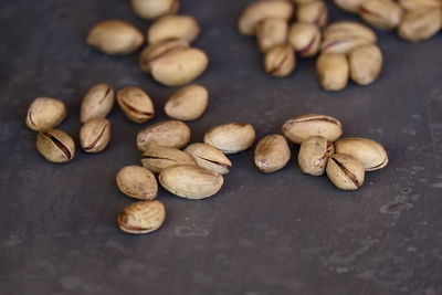 Close-up of pistachios on gray table