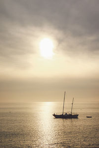 High angle view of boat sailing in sea against sky during sunset