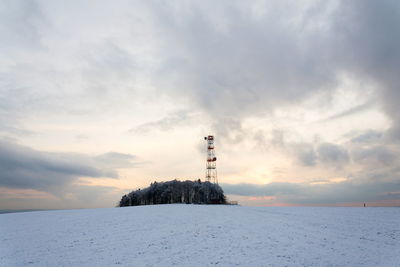 Lighthouse against sky during winter
