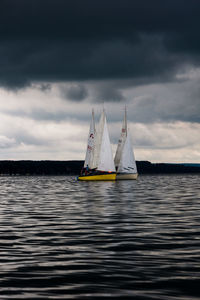 Sailing boat against stormy sky.