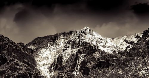 Low angle view of mountain range against sky