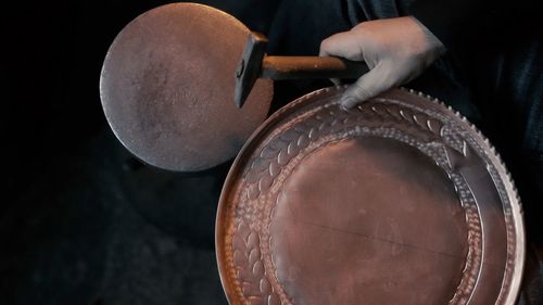 Cropped hand of man holding container