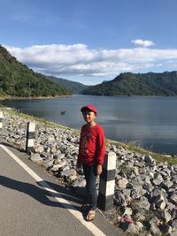 Full length of man standing on lake against sky