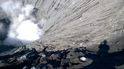 High angle view of shadow on rock formation in geyser