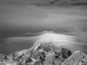 Scenic view of snow covered mountains against sky