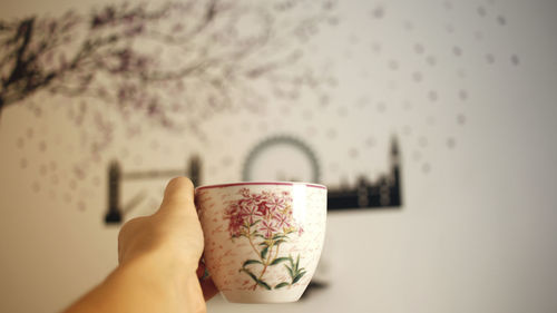 Midsection of person holding coffee cup