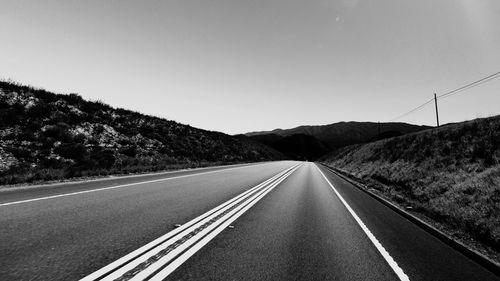 Empty country road against clear sky