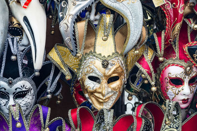 Close-up of venetian masks at market stall