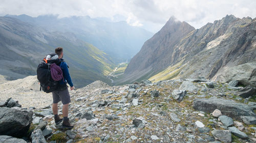 Rear view of man walking on mountain