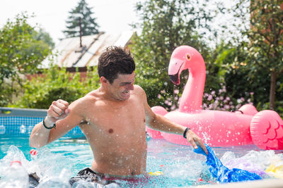 Full length of shirtless boy in swimming pool