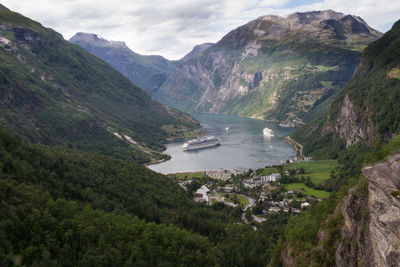 Scenic view of sea and mountains against sky