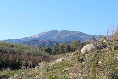 Scenic view of mountains against clear blue sky