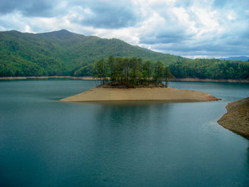 Scenic view of lake against cloudy sky