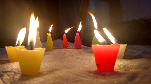 Close-up of lit candles on birthday cake