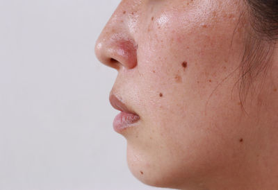 Close-up portrait of a girl over white background