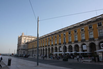 Buildings in city against clear sky