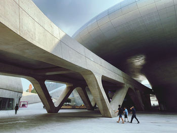 People walking on bridge in city