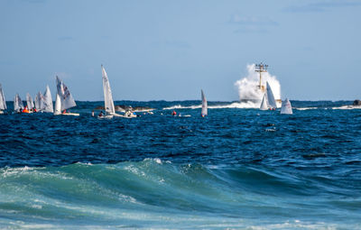 Sailboat sailing on sea against sky