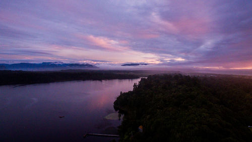 Scenic view of lake against sky at sunset