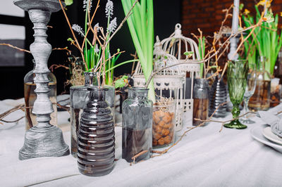 Table setting in a mysterious spring style with live plants and branches.