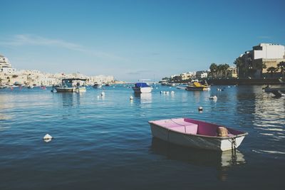 Boats in harbor in city