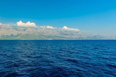 Scenic view of sea against blue sky