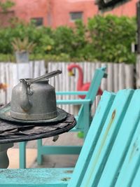 Close-up of metal seat on table in yard