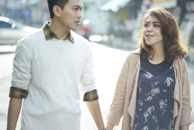 Young couple standing outdoors