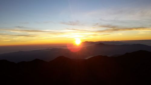 Scenic view of silhouette mountains against sky during sunset