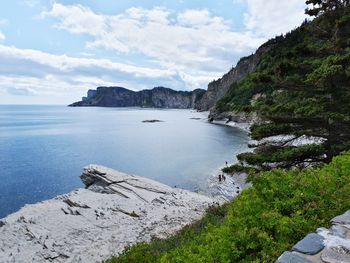 Scenic view of sea and mountains against sky