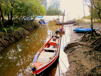 Sailboats moored in river