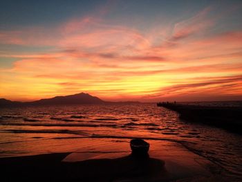 Scenic view of sea against orange sky