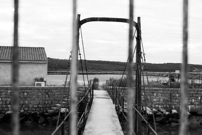 Bridge over river against buildings in city